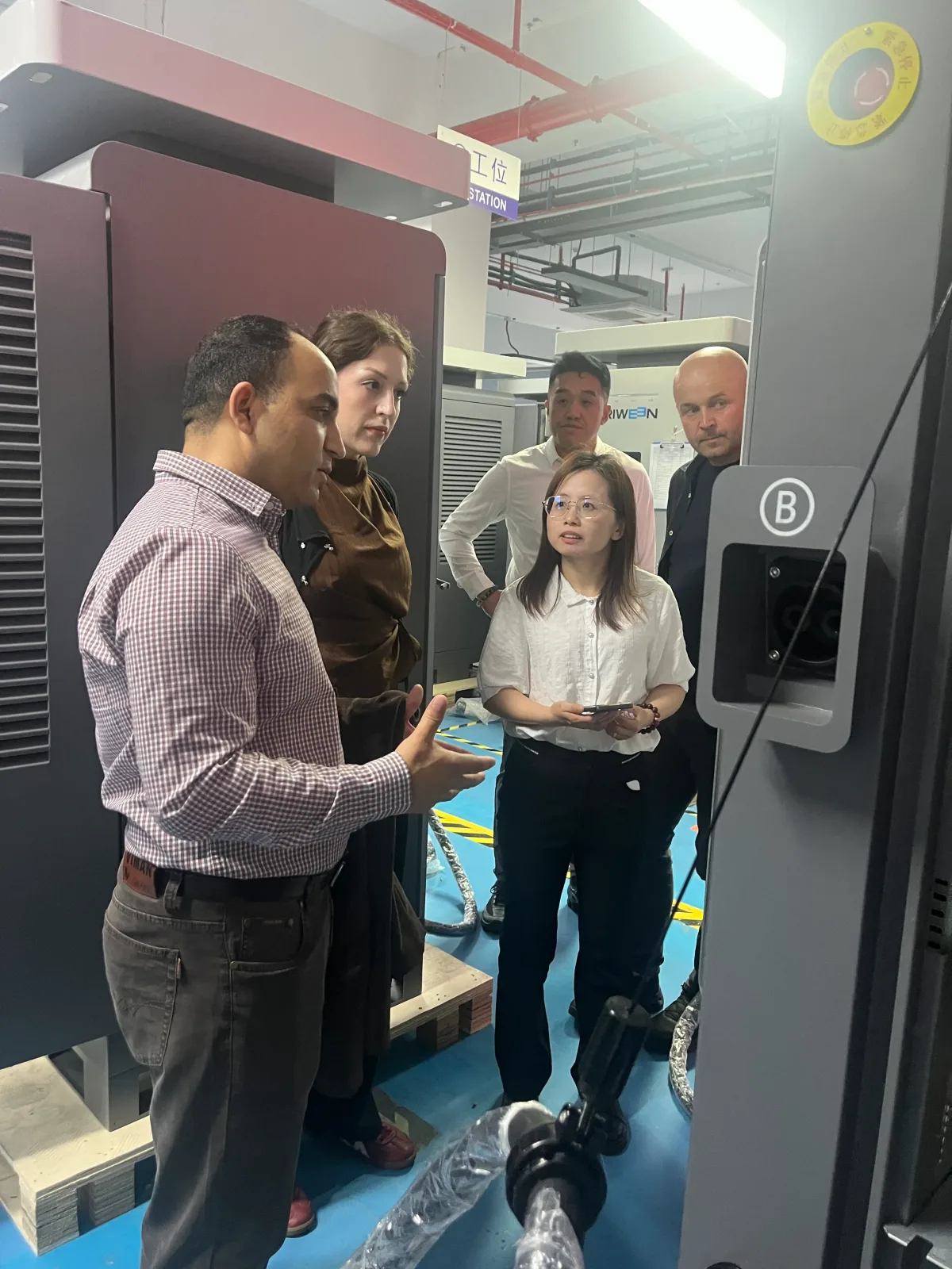 Technical tour of a Klitv EV charger — engineers demonstrating configuration and testing